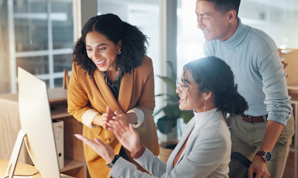 Team collaborating on computer with AI Agents
